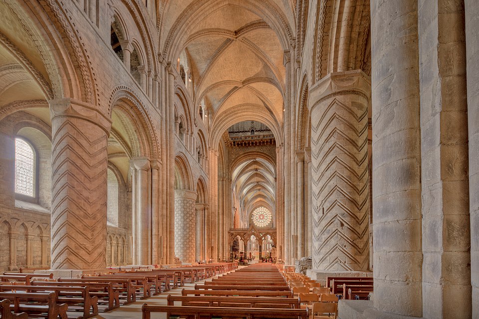 Interior view of Durham Cathedral nave, showing arches and vaulted ceiling.