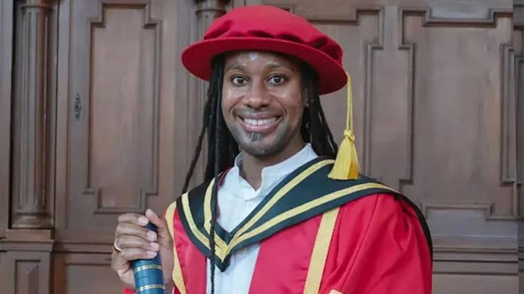 Jason Arday wearing red academic dress